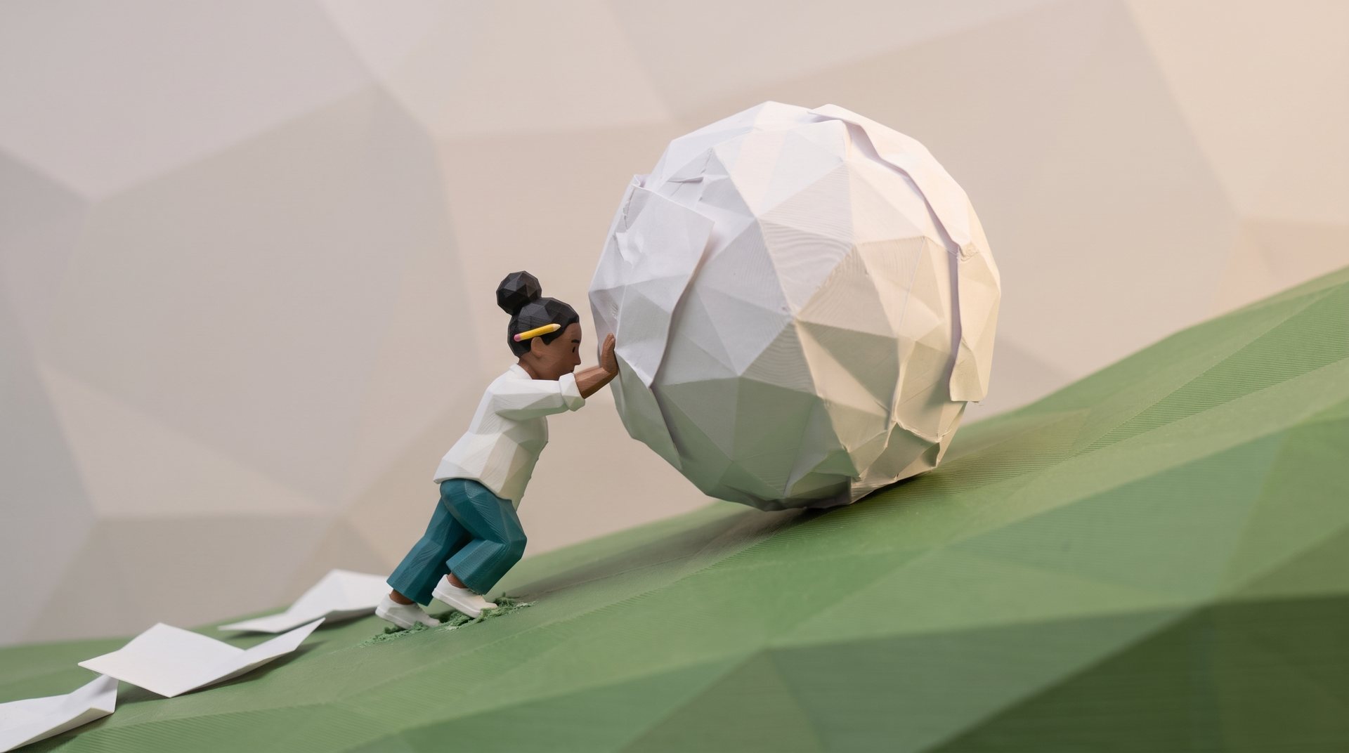 A polybit figure pushes a giant ball of crumpled paper up a grassy hill.